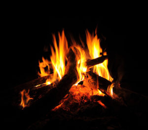 A fire burning in the dark with black background