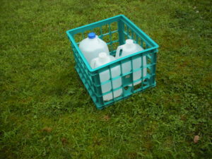 Crate Holding Water Jugs