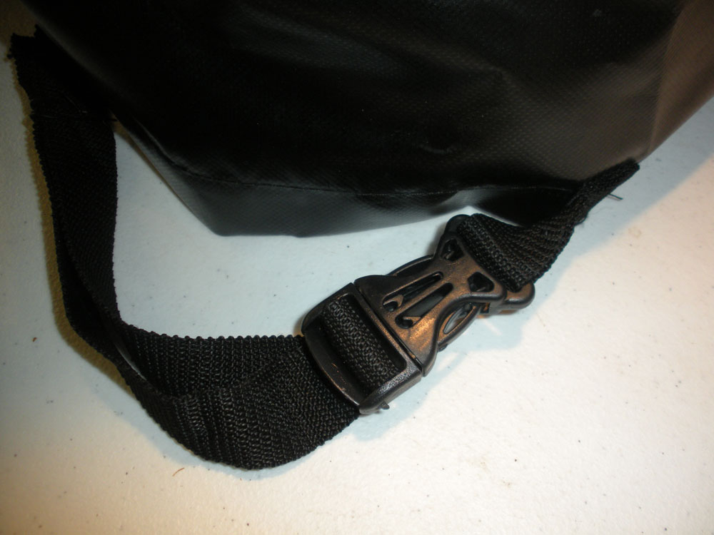 A black bag with a strap attached to it.