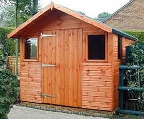 outdoor wooden shed with one closed door and 2 windows located in a backyard garden