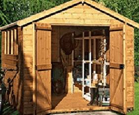 wooden shed with an A framed roof and 2 doors opened with items stored inside