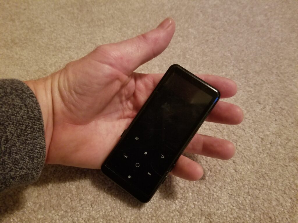 black MP3 player resting in palm of hand
