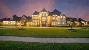 mansion with front lit up with lights