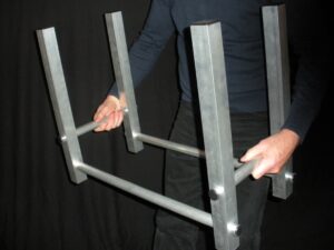aluminum TFH-1 firewood holder being held by 2 hands 